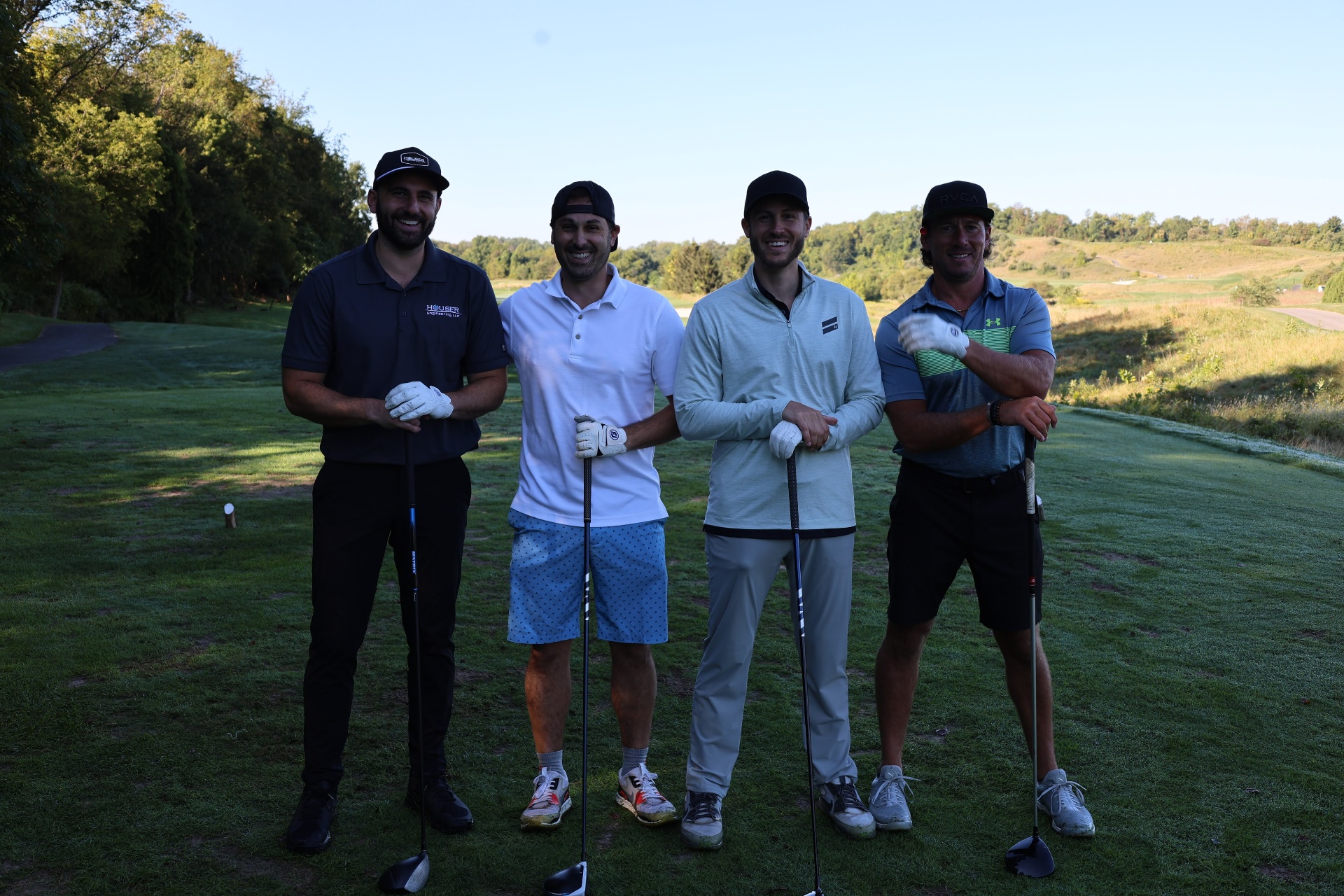 Foursome at the tee box at sunrise