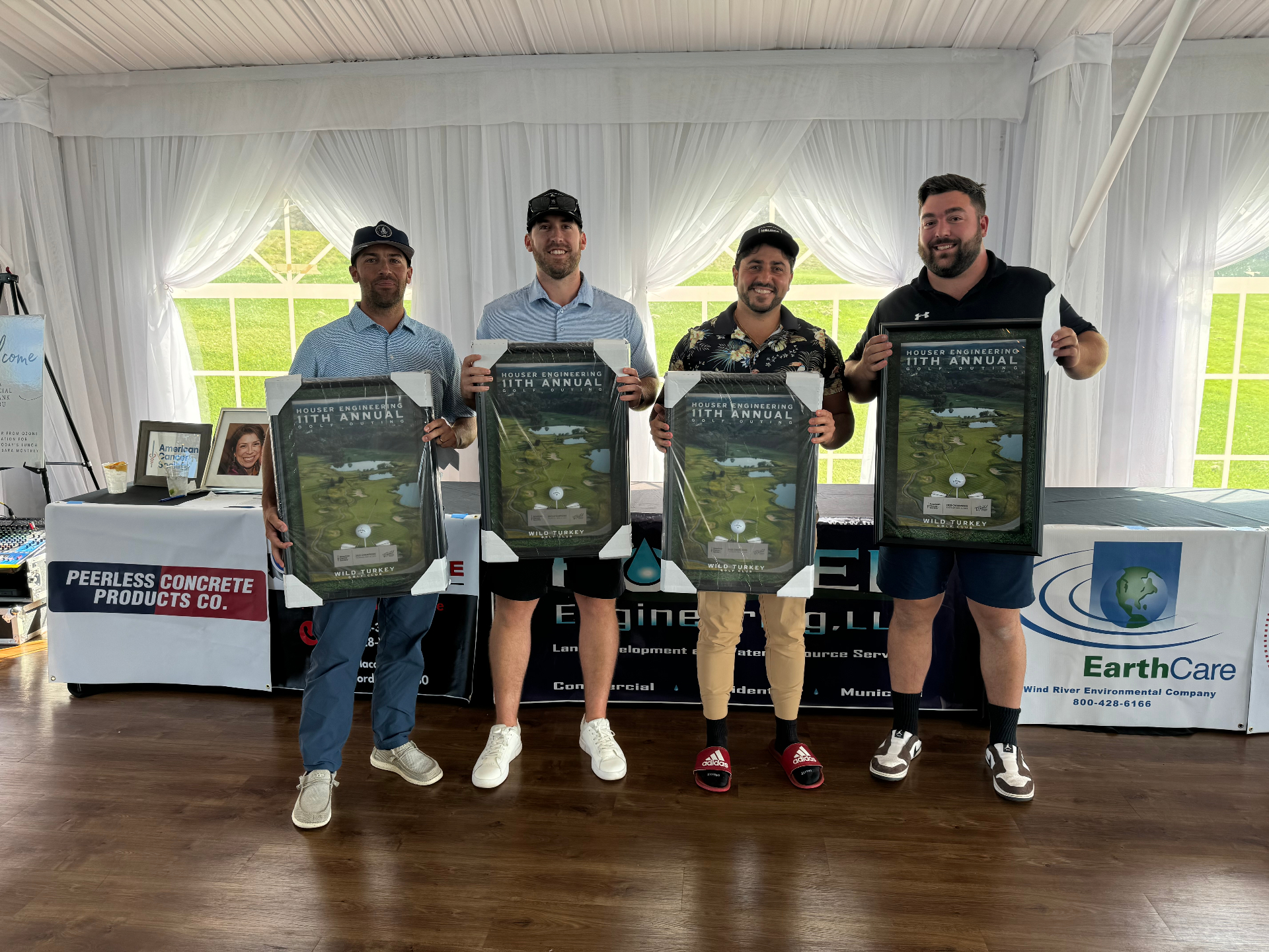 Winning foursome holding 11th Annual Houser Engineering Golf Outing plaques